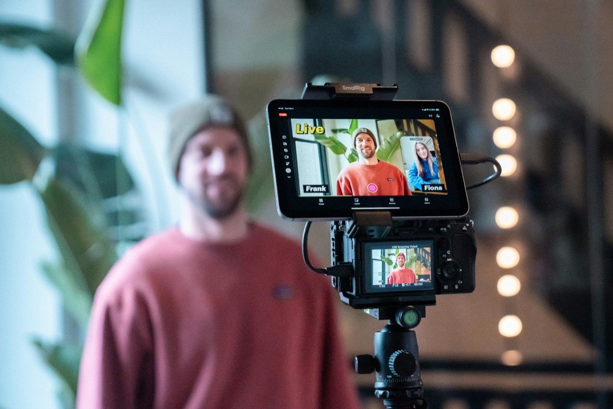 A camera on a tripod streaming a live interview
