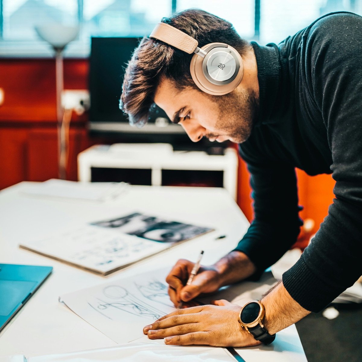 A designer sketching brand concepts at a desk